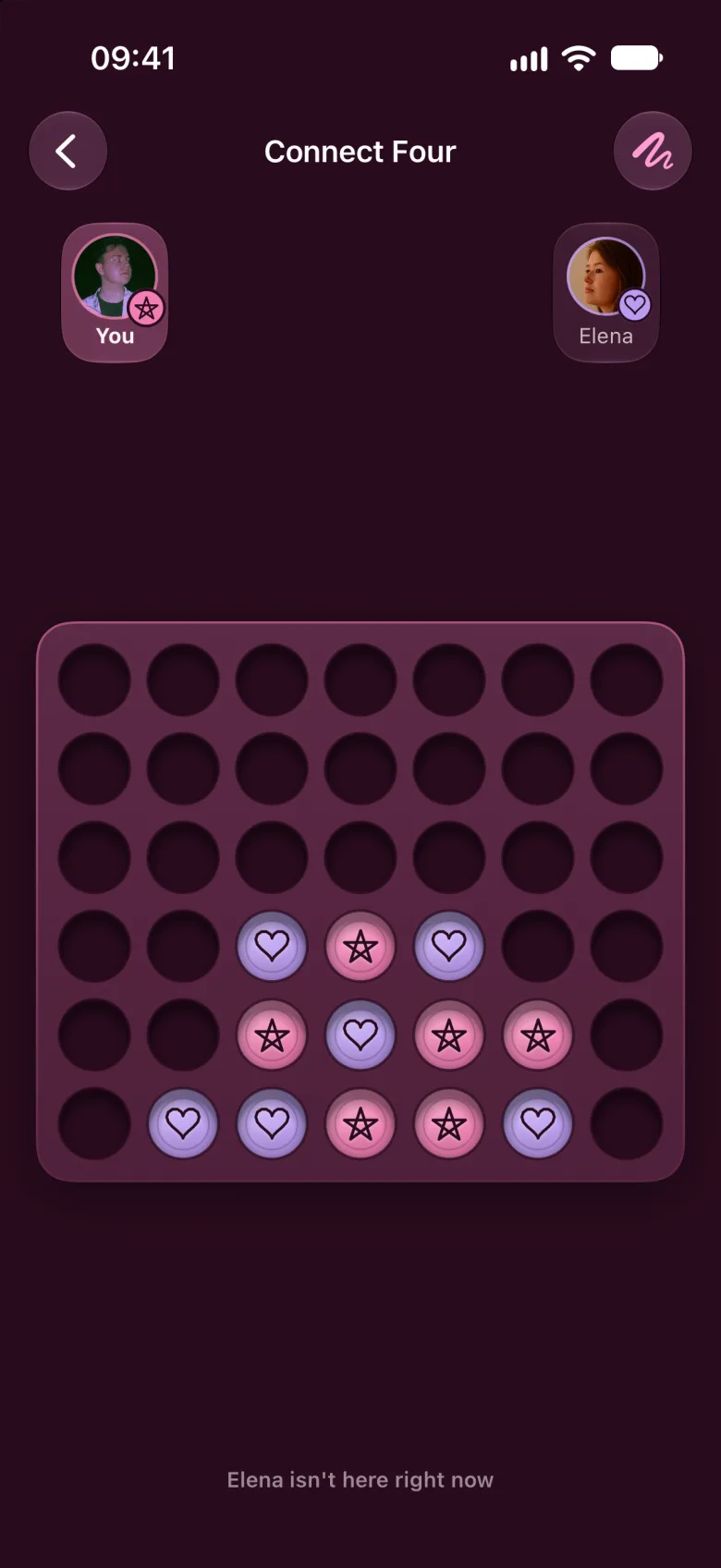 A game of Connect Four where one player's discs have a hand-drawn star and the other's a heart.
